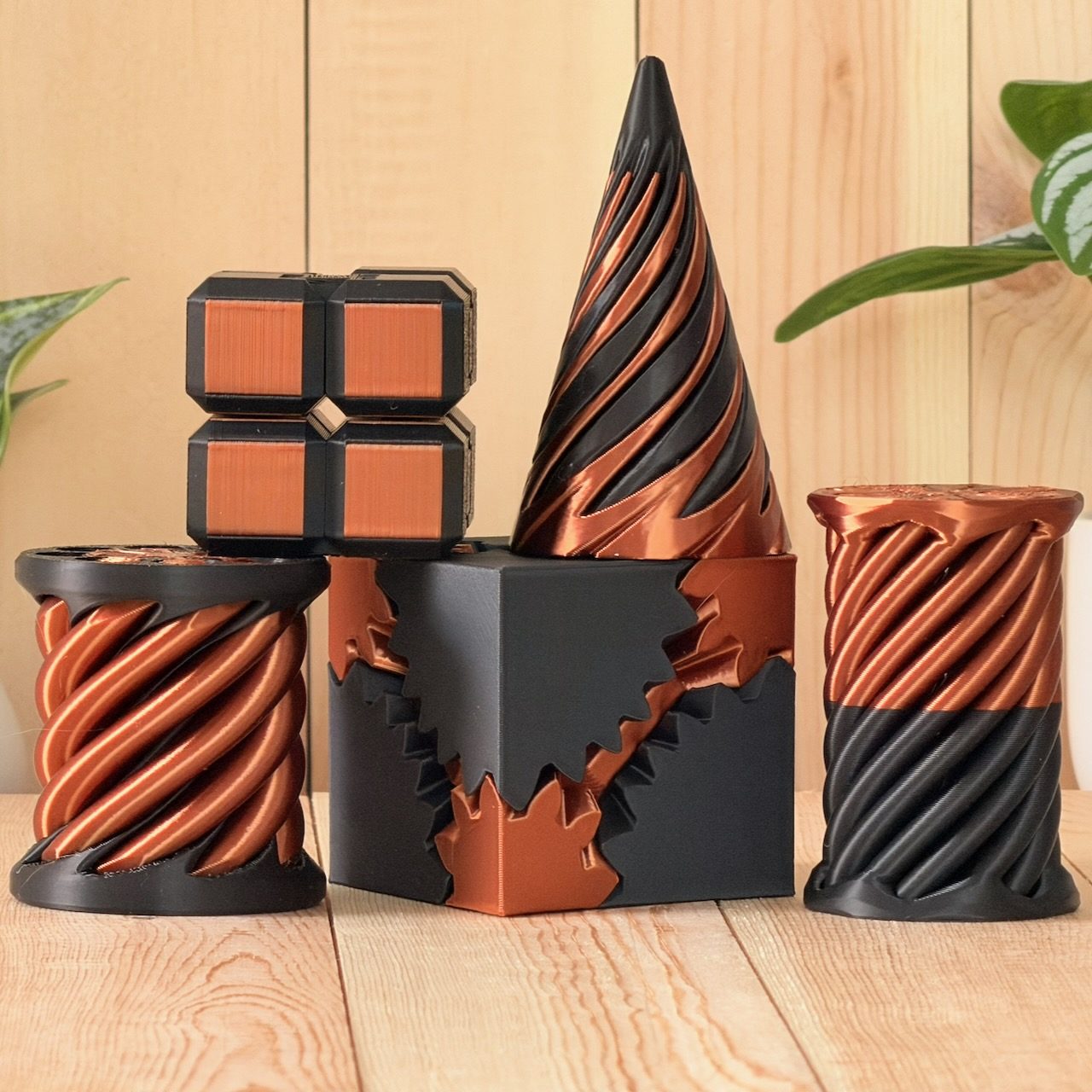 Four piece fidget desk set with copper and black gear cube, fold cube, spiral cone and twist spool